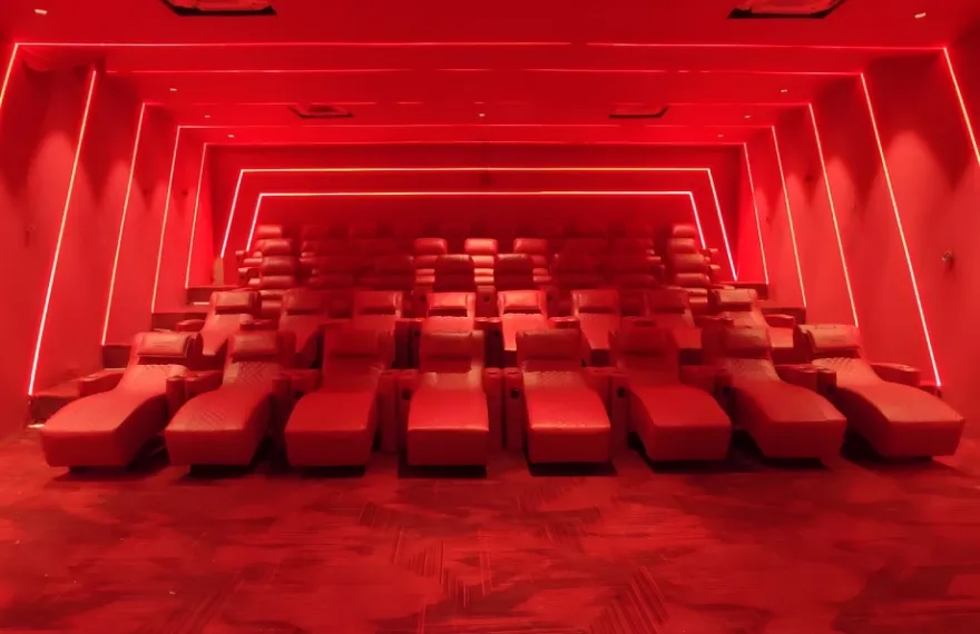 Clubhouse screening room with red recliners